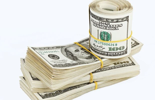Bundles and a roll of hundred-dollar bills