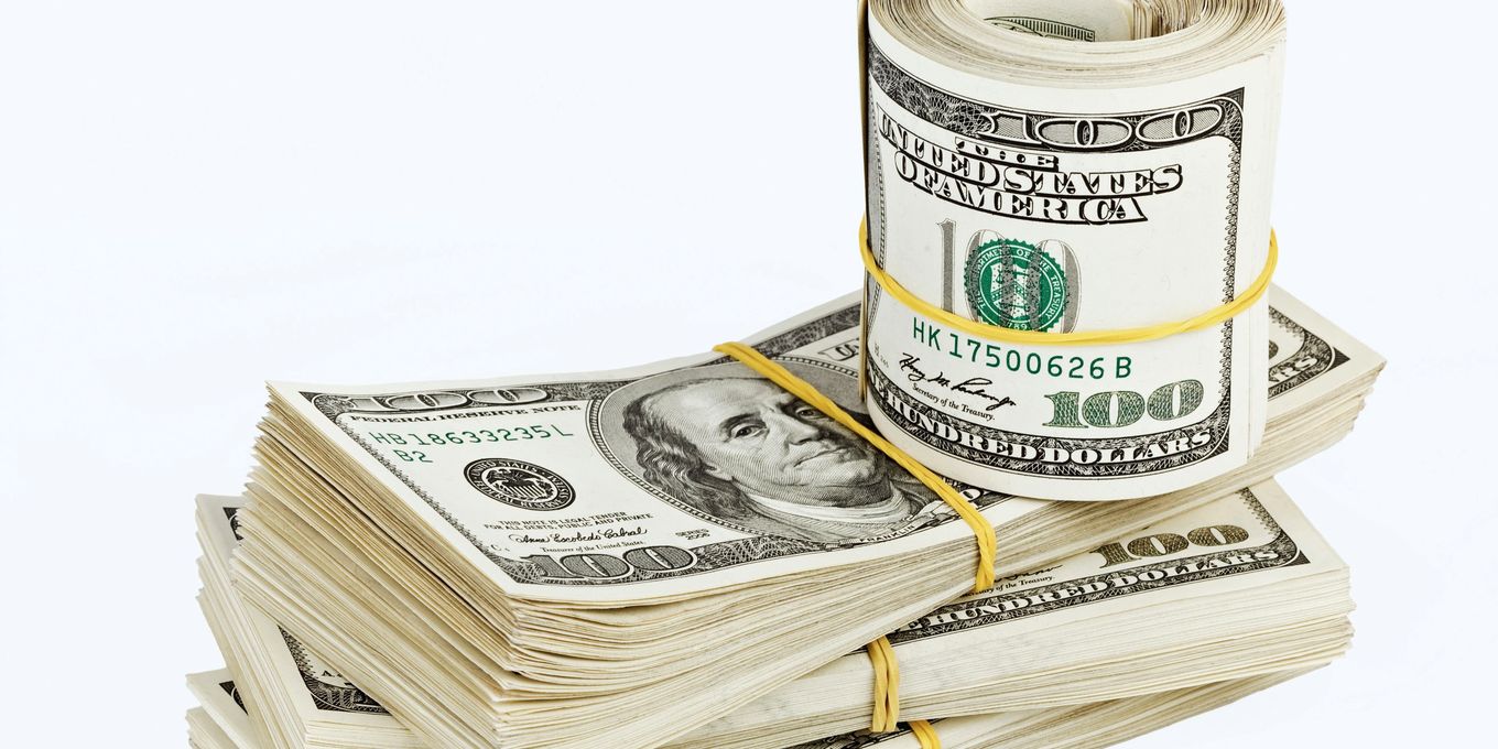Bundles and a roll of hundred-dollar bills
