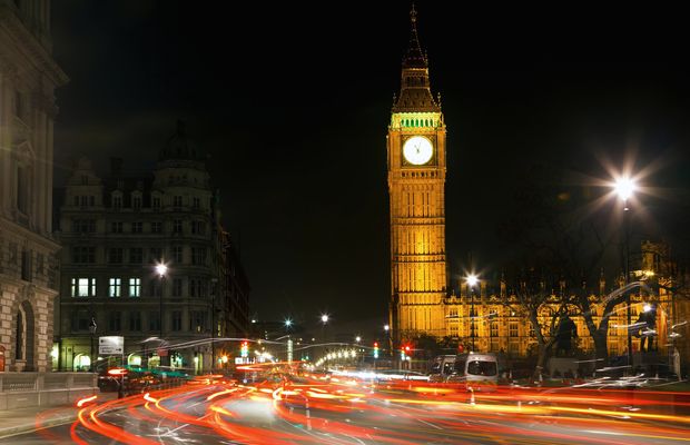 Traffic light trails in Westminster at night below the clock tower