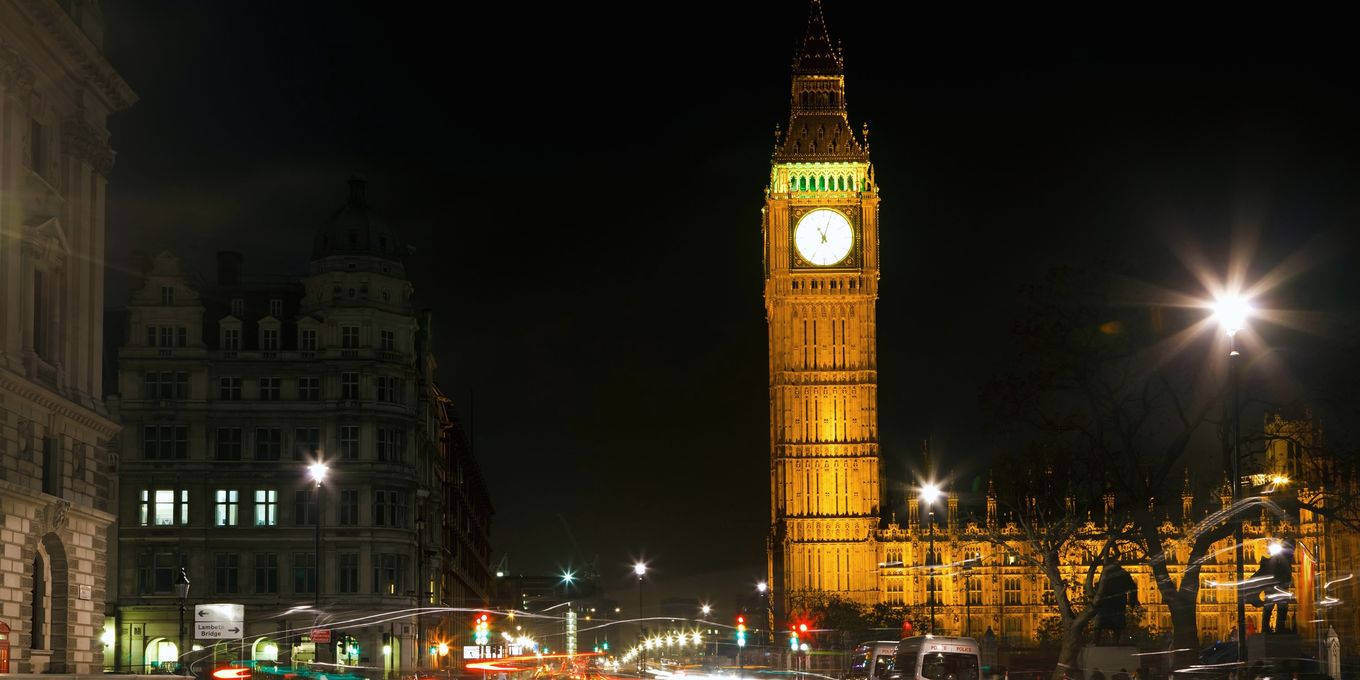 Traffic light trails in Westminster at night below the clock tower